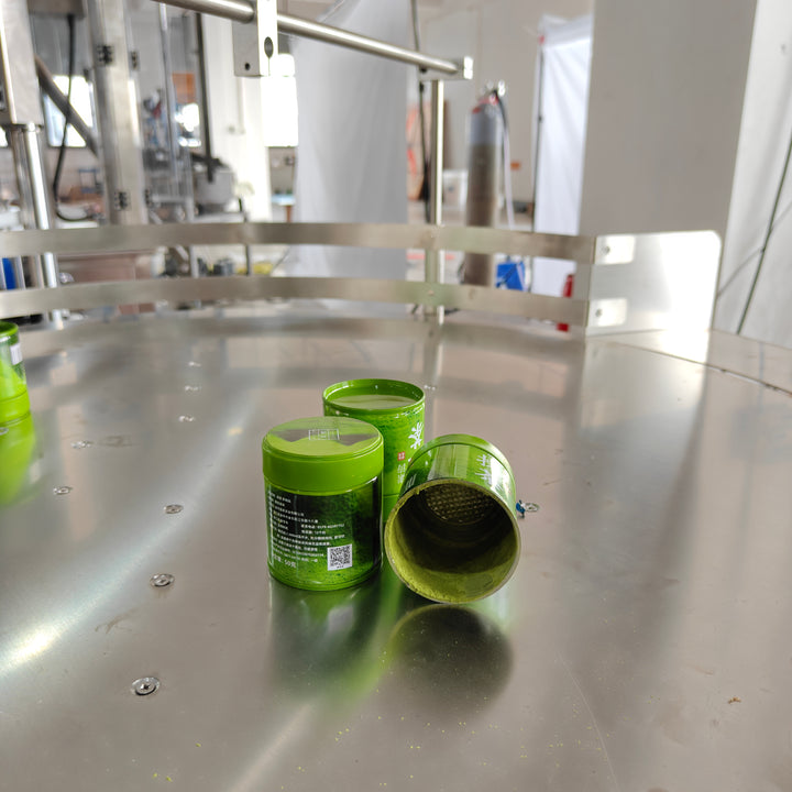 Filled matcha powder cans output from automatic filling line - Tranfull
