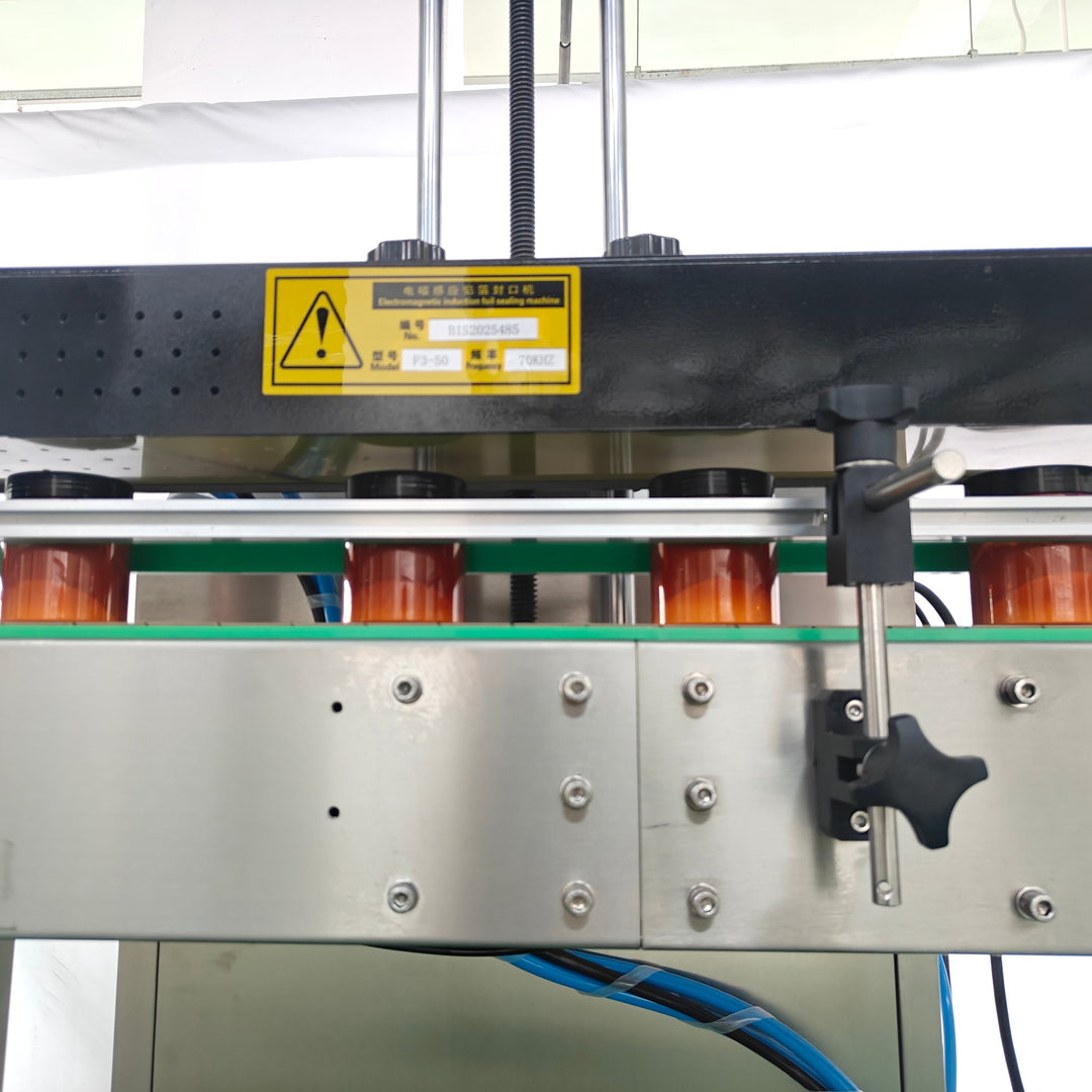 Induction foil sealer conveyor belt close-up - Tranfull